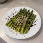 Delicious asparagus drizzled with balsamic glaze on a plate