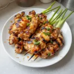 Delicious grilled Vietnamese chicken garnished with fresh herbs