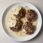Hamburger steaks served in a creamy dill sauce for a delicious meal