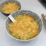Bowl of homemade egg drop soup garnished with green onions