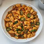 Plate of spicy Jalapeno Chicken garnished with fresh herbs