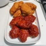 Delicious serving of Korean Fried Chicken with crispy coating and spicy sauce