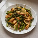Lemon Chicken Stir-Fry with asparagus garnished and served in a bowl