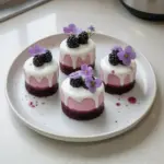 Delicious mini blackberry mousse cakes topped with fresh blackberries