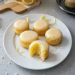 Mini lemon drop cakes with a soft texture and lemon glaze on top.
