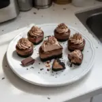Mini triple chocolate cheesecakes topped with chocolate shavings