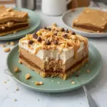 Delicious peanut butter lasagna with layers of creamy goodness and chocolate topping.