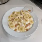 Creamy protein banana pudding served in a bowl with bananas and protein powder