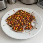 Homemade Reese's Bark with chocolate and peanut butter on a cooling rack.