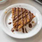 Samoa Pie with chocolate, coconut, and caramel layers on a dessert plate