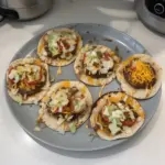 Delicious Smashed Cheeseburger Tacos served with fresh toppings and sauces.