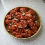 Crispy spicy Korean Fried Chicken served on a plate with garnishes