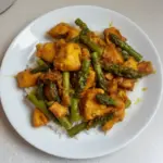 Delicious Turmeric Black Pepper Chicken served with vegetables on a plate