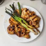 Vietnamese grilled chicken garnished with herbs and served with rice