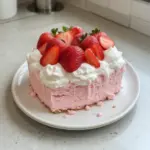 A delicious slice of no bake strawberry cloud cake with fresh strawberries.