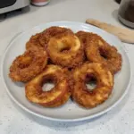Air fryer cinnamon apple rings garnished with cinnamon and served in a bowl.