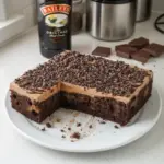 Decadent Baileys Chocolate Poke Cake topped with chocolate drizzle