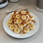 Biscoff Banana Pudding dessert with layers of banana and Biscoff cookie crumbles