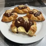 Boston Cream Pie Croissants topped with chocolate and cream filling