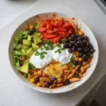 Delicious Chicken Enchilada Bowl topped with fresh ingredients and herbs