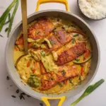Coconut curry salmon served with aromatic rice and fresh herbs