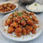 Crispy Honey Garlic Chicken served on a plate with garnish.