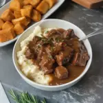 Easy crock pot beef tips served with rich gravy on a plate