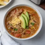 Bowl of easy ground venison taco soup garnished with cheese and cilantro