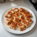 High protein pepperoni pizza rolls served on a plate