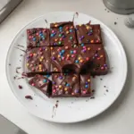 Homemade cosmic brownies with fudge icing and colorful sprinkles
