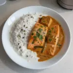 Indian-style salmon curry with coconut milk served in a bowl