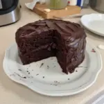 A sumptuous slice of Matilda's chocolate cake, rich and moist, ready to be enjoyed.