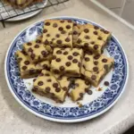Delicious melt-in-your-mouth chocolate chip cookie bars on a plate