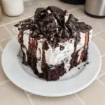 Delicious Oreo Poke Cake with chocolate and cream layer