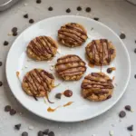 Peanut butter chocolate caramel cookies stacked on a plate