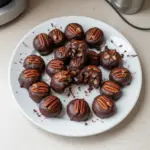 Delicious Pecan Pie Brownie Bites topped with crunchy pecans