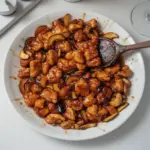 Delicious spicy orange chicken served with rice and vegetables.