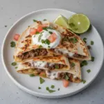 Delicious ground venison quesadillas with melted cheese and fresh toppings