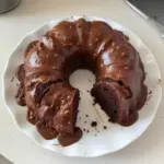 Texas Sheet Cake Bundt Cake with chocolate frosting and nuts